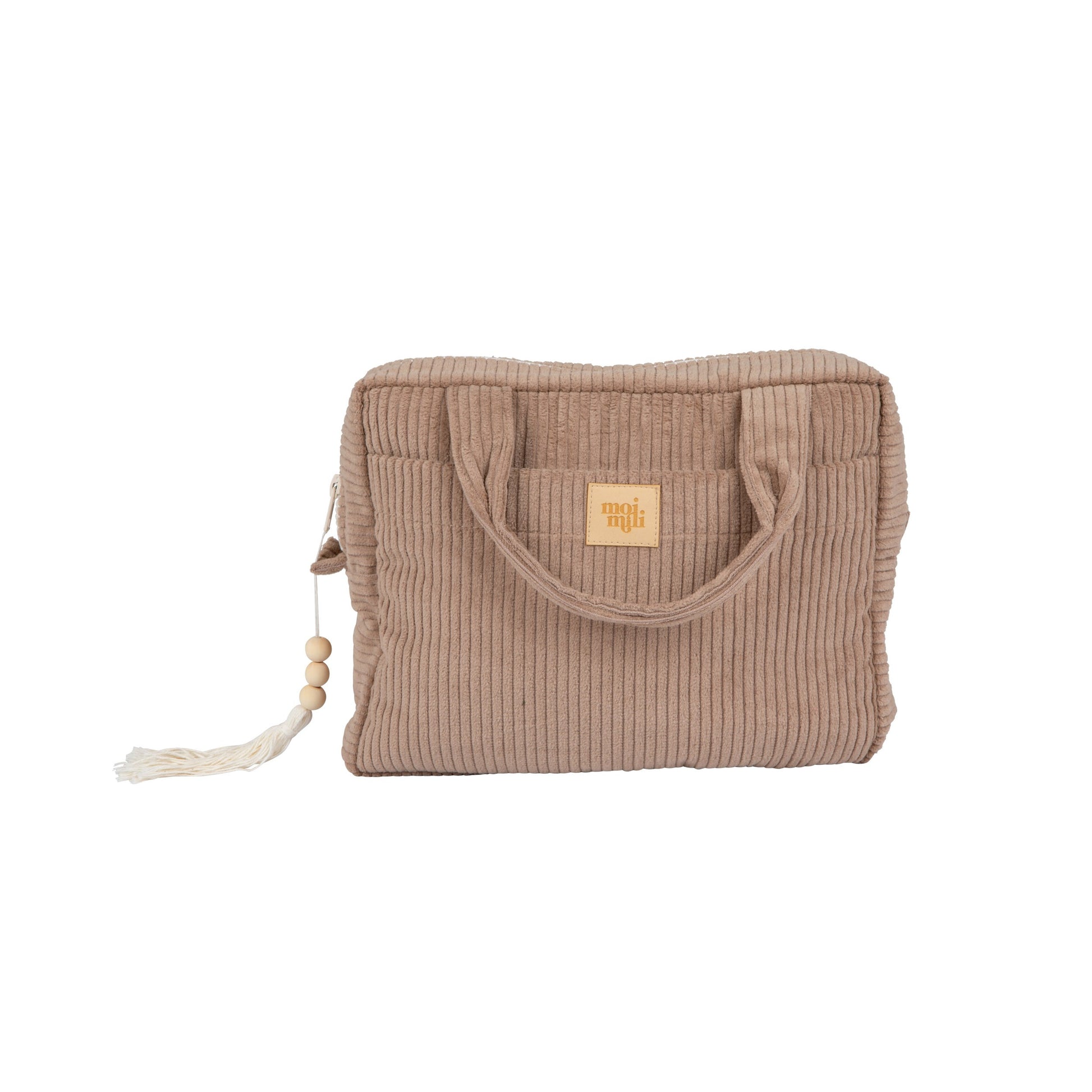 handmade latte makeup bag open on a sandy beach towel showing its waterproof lining and pockets