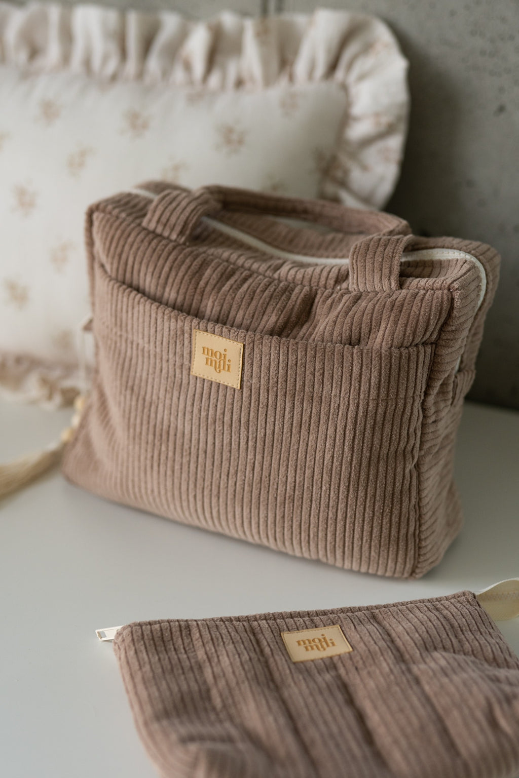 functional latte-colored cotton makeup bag with waterproof lining, open to show inner pockets for travel essentials
