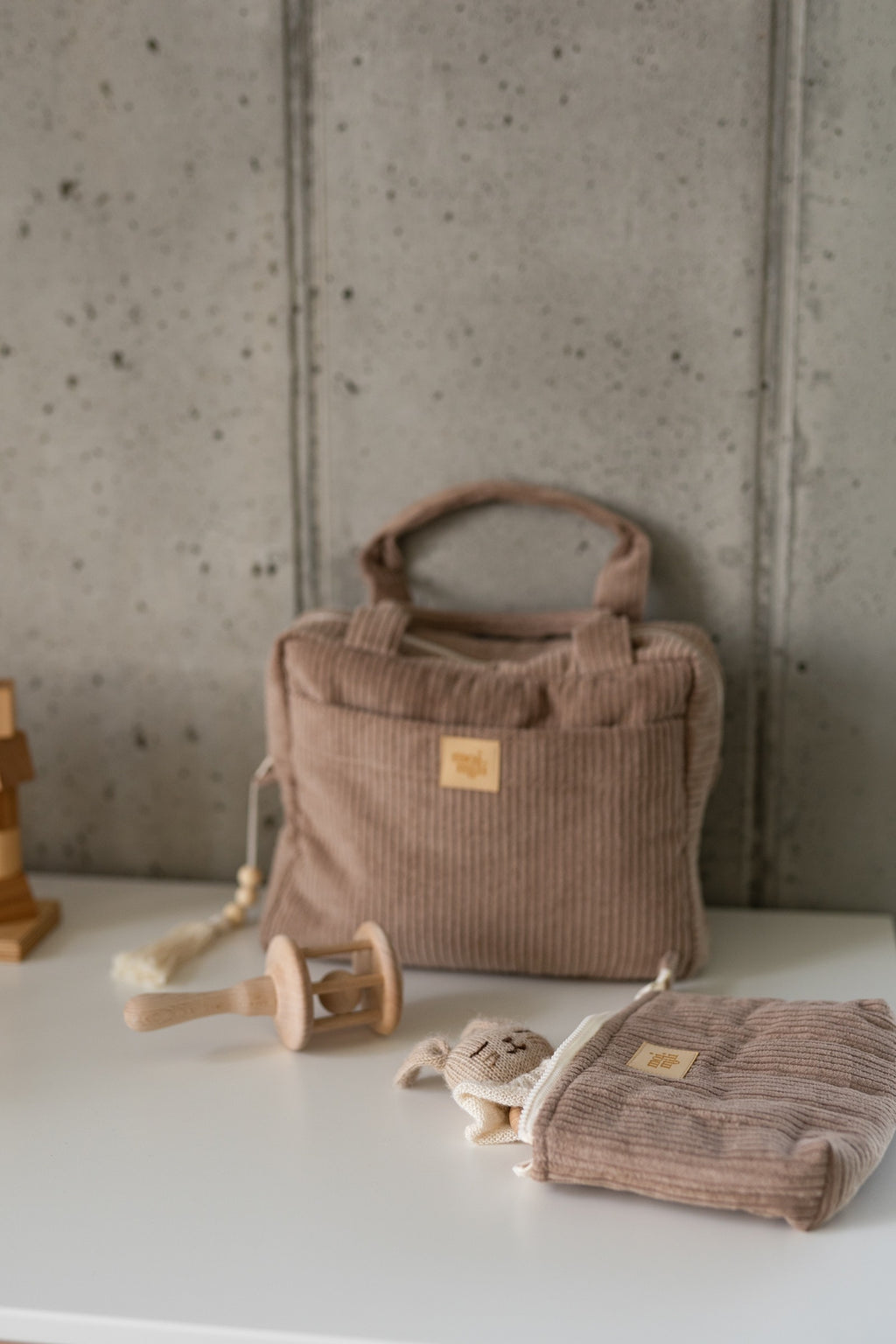 handmade latte makeup bag open on a rustic table showing its waterproof lining and inner pocket
