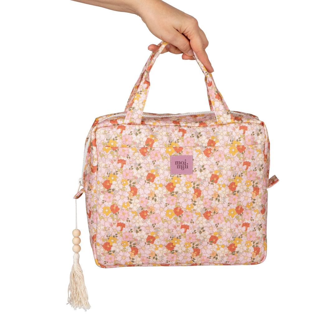 bold spring garden makeup bag set open on a marble surface showcasing its chic design and spacious interior
