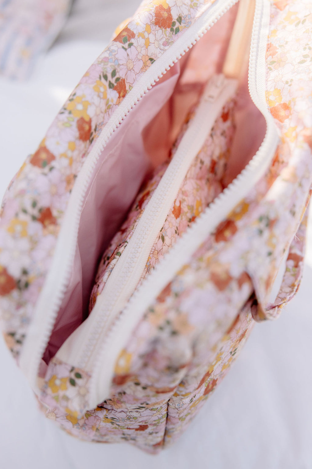 elegant spring garden makeup bag set arranged on a marble surface with soft morning light