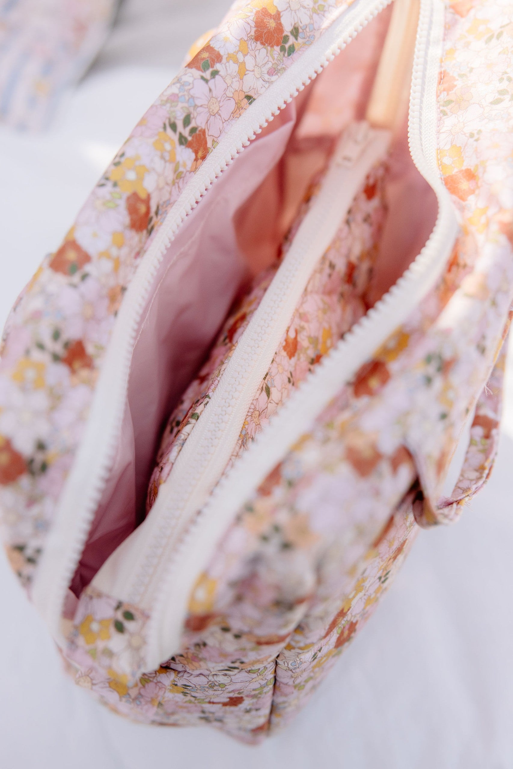 elegant spring garden makeup bag set arranged on a marble surface with soft morning light