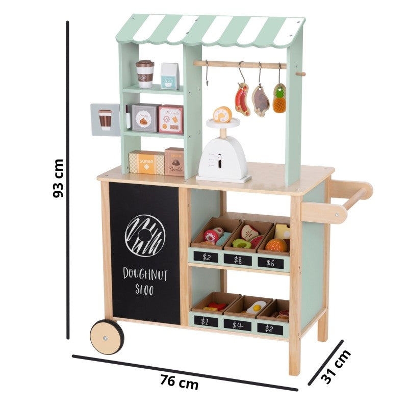 a child's hand gently placing wooden fruit on the food truck's scale