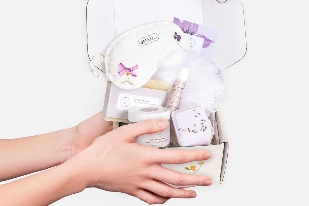 softly lit lavender bath set with eye mask and soap bar on a cozy linen background