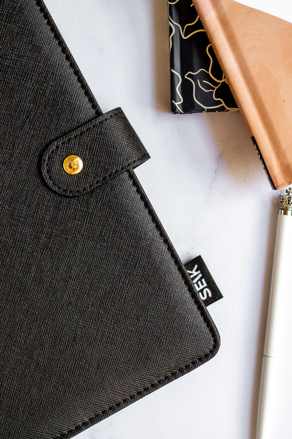 close-up of a vegan leather notebook showing its functional card slots and pen holder