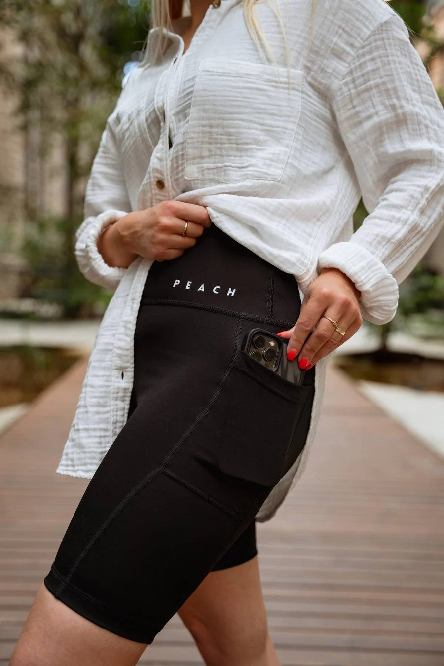 elegant high-waisted black biker shorts with side pockets on a minimalist background