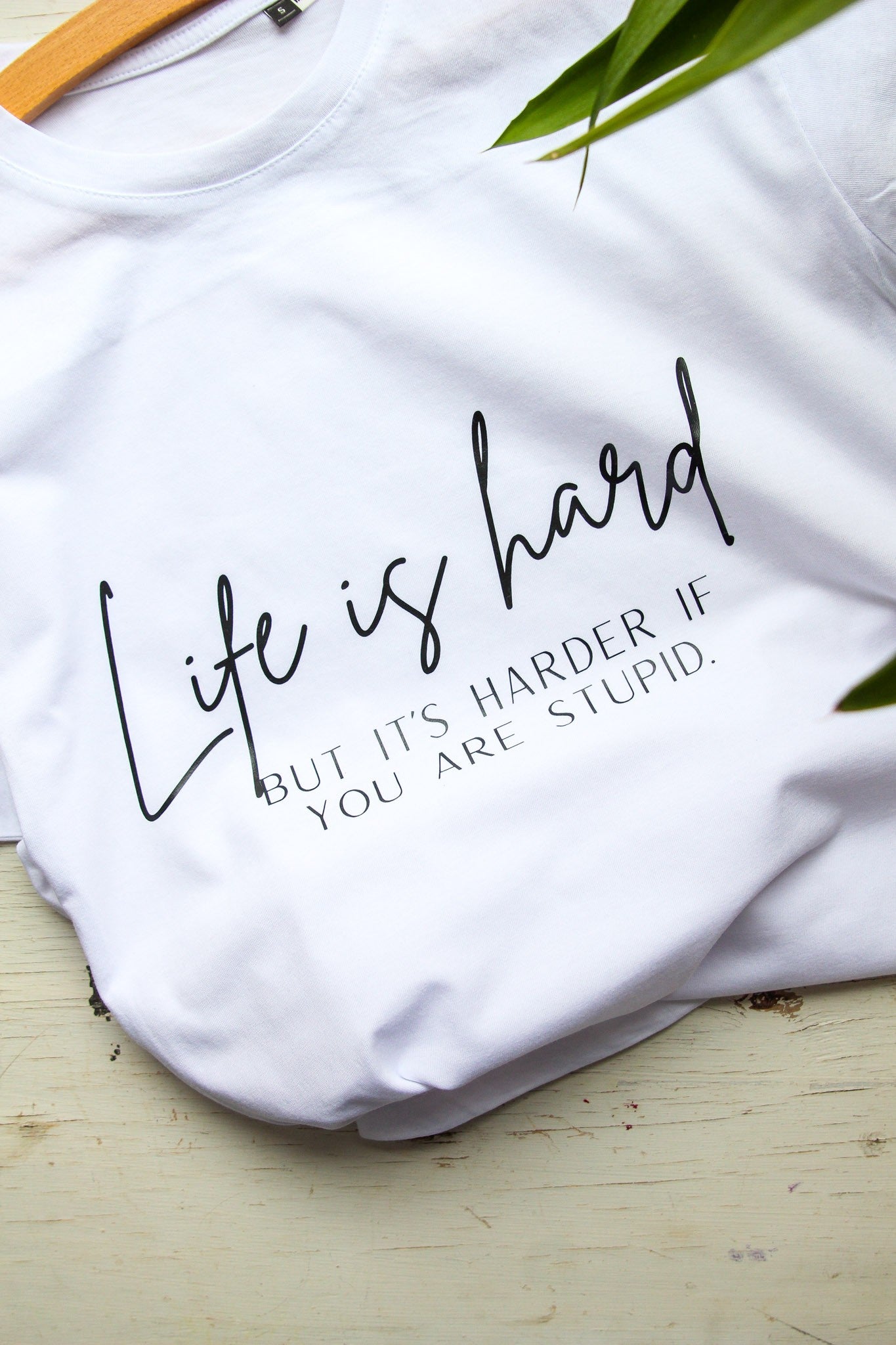 a woman relaxing in a soft oversized life is hard t-shirt with comforting morning light