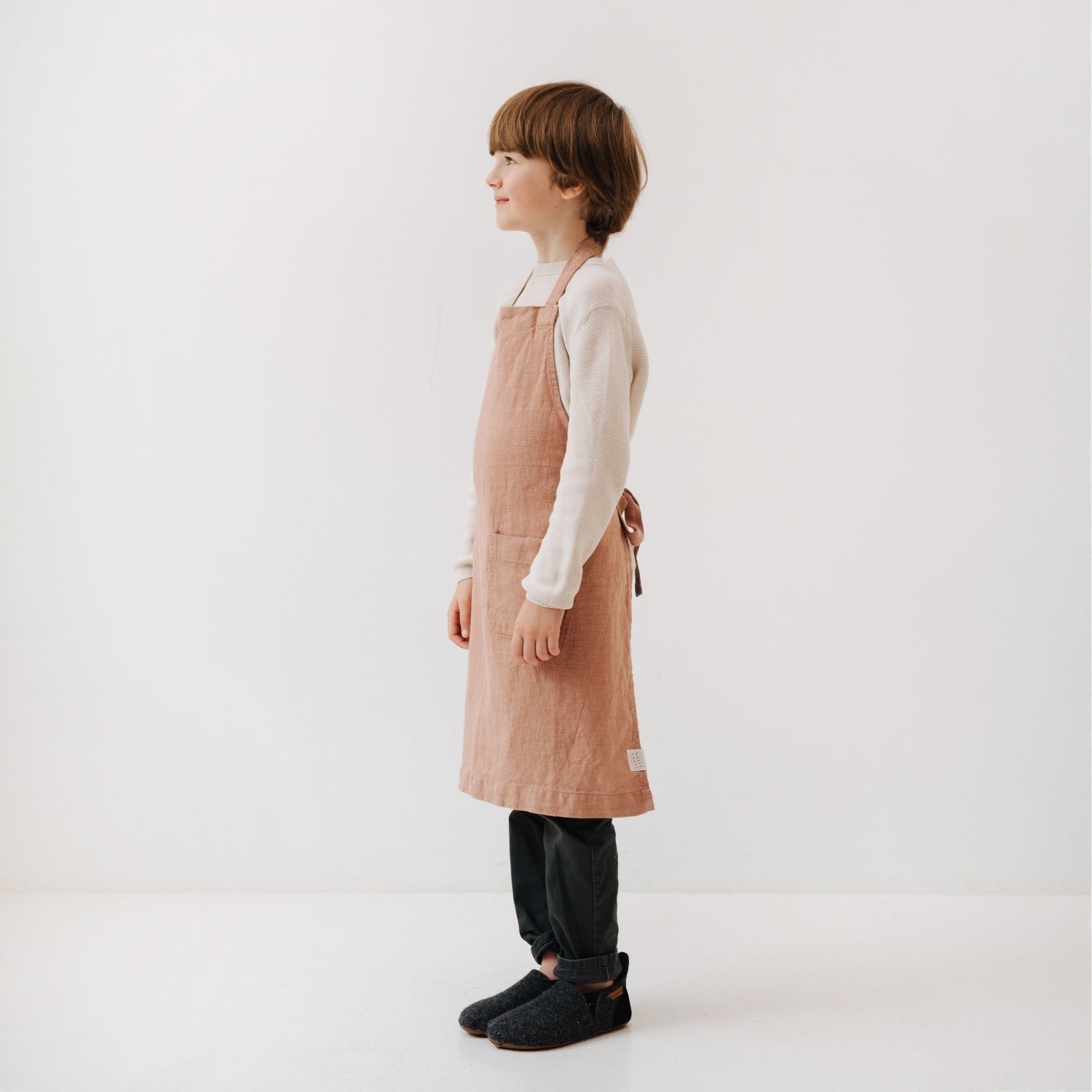 practical kids linen apron with a deep front pocket for holding kitchen utensils