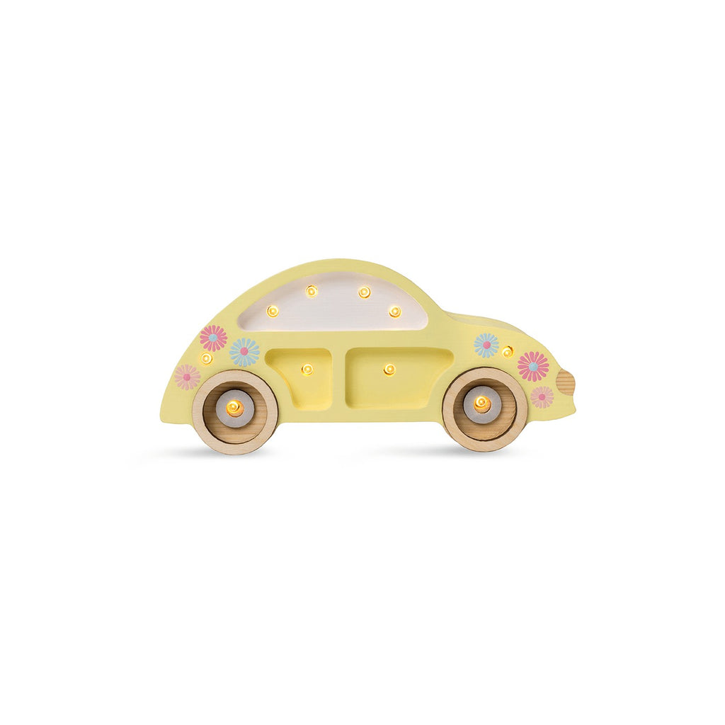 a soft glow from the handcrafted pinewood beetle car lamp on a cozy bedside table
