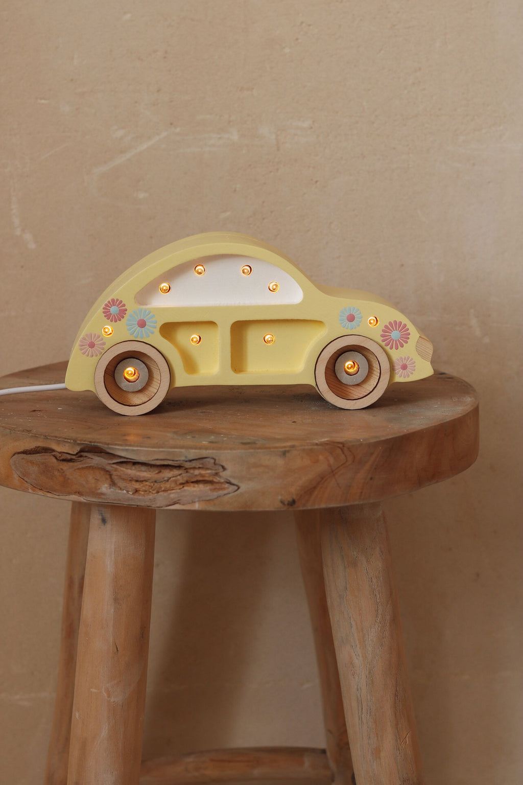 elegant pinewood beetle car lamp casting a warm glow on a nightstand