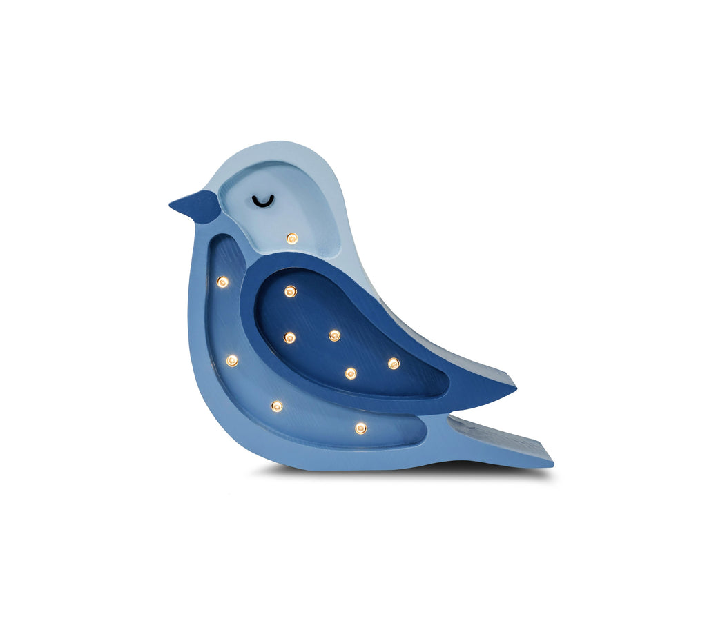 bold artisan-made bird lamp casting a warm glow on a childs bedside table