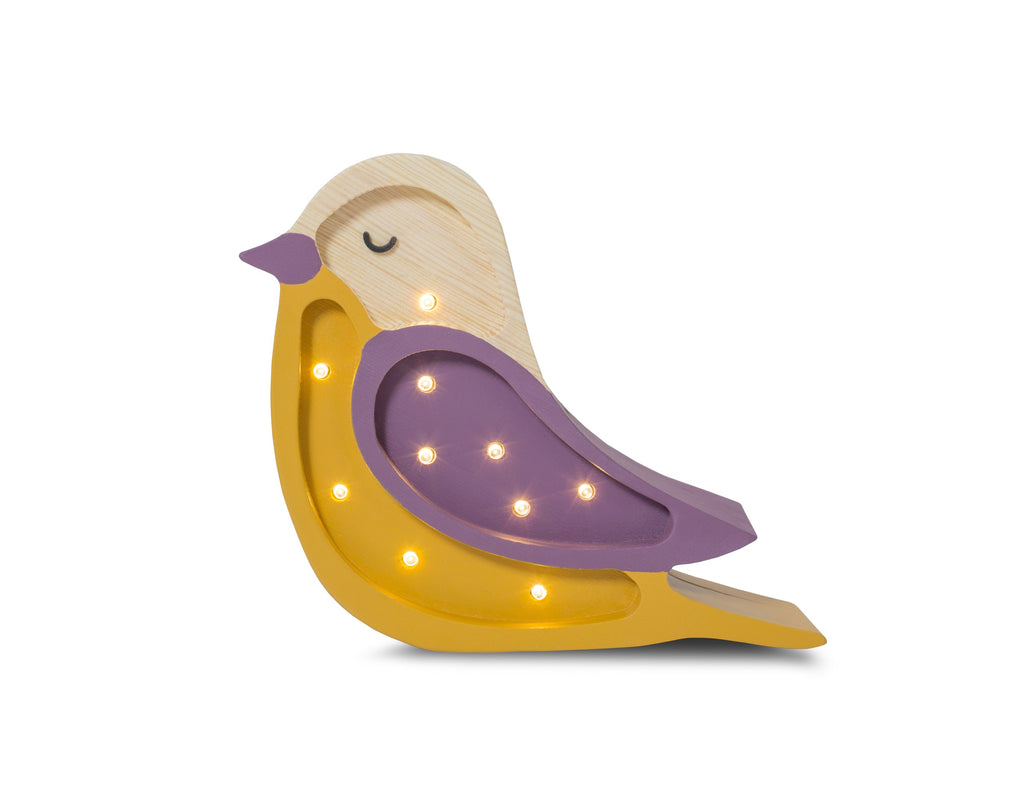 handmade pine wood bird lamp casting a soft glow on a childs nightstand