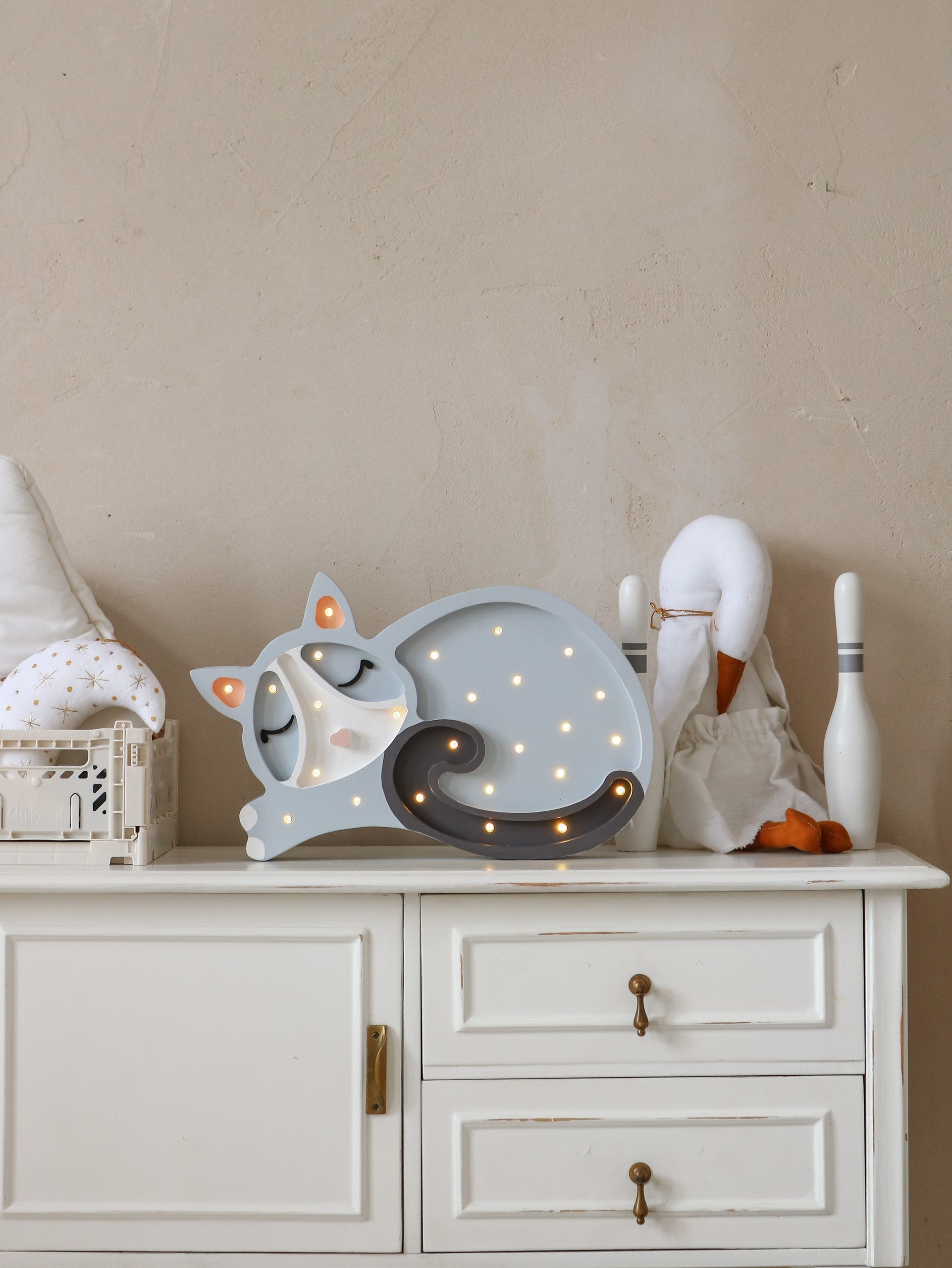handcrafted pine wood cat lamp casting a soft warm glow on a nursery shelf