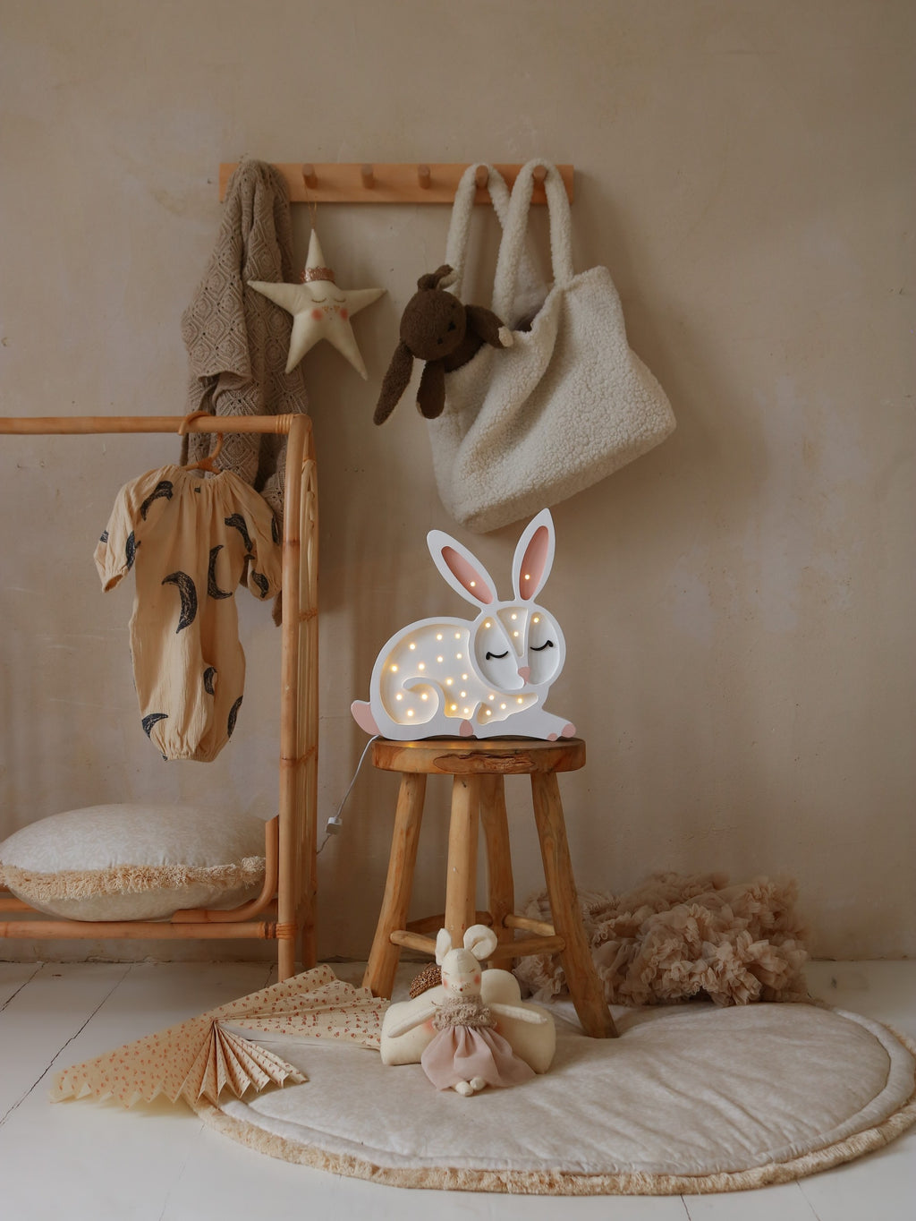 a child's hand gently touching the warm glow of the artisan-crafted wooden cat night light