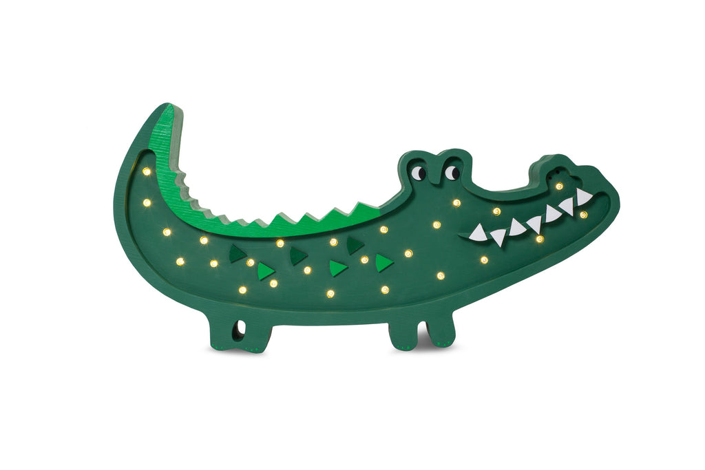 bold close-up of the handcrafted crocodile lamp in warm light on a dark wood surface