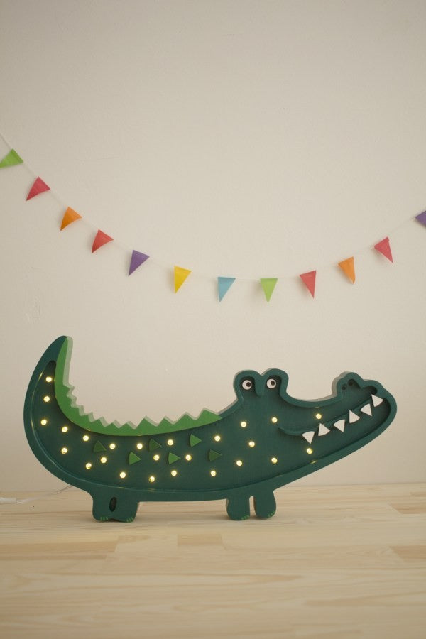 a close-up view of the crocodile lamp's handcrafted pine wood texture and warm led light