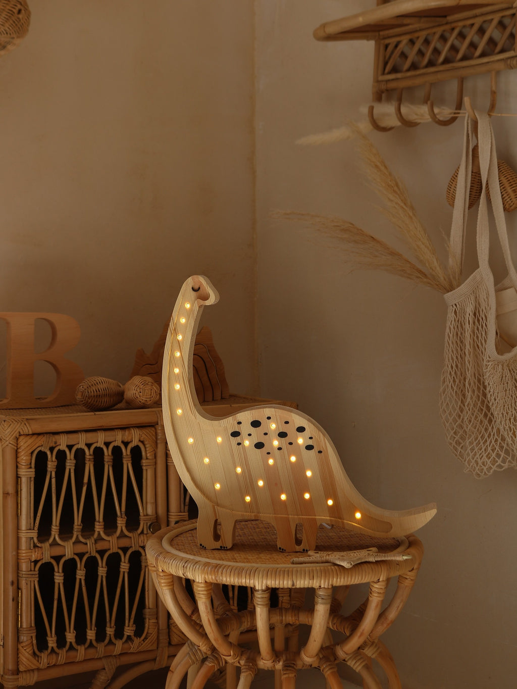 bold diplodocus lamp casting a warm glow in a modern childs bedroom