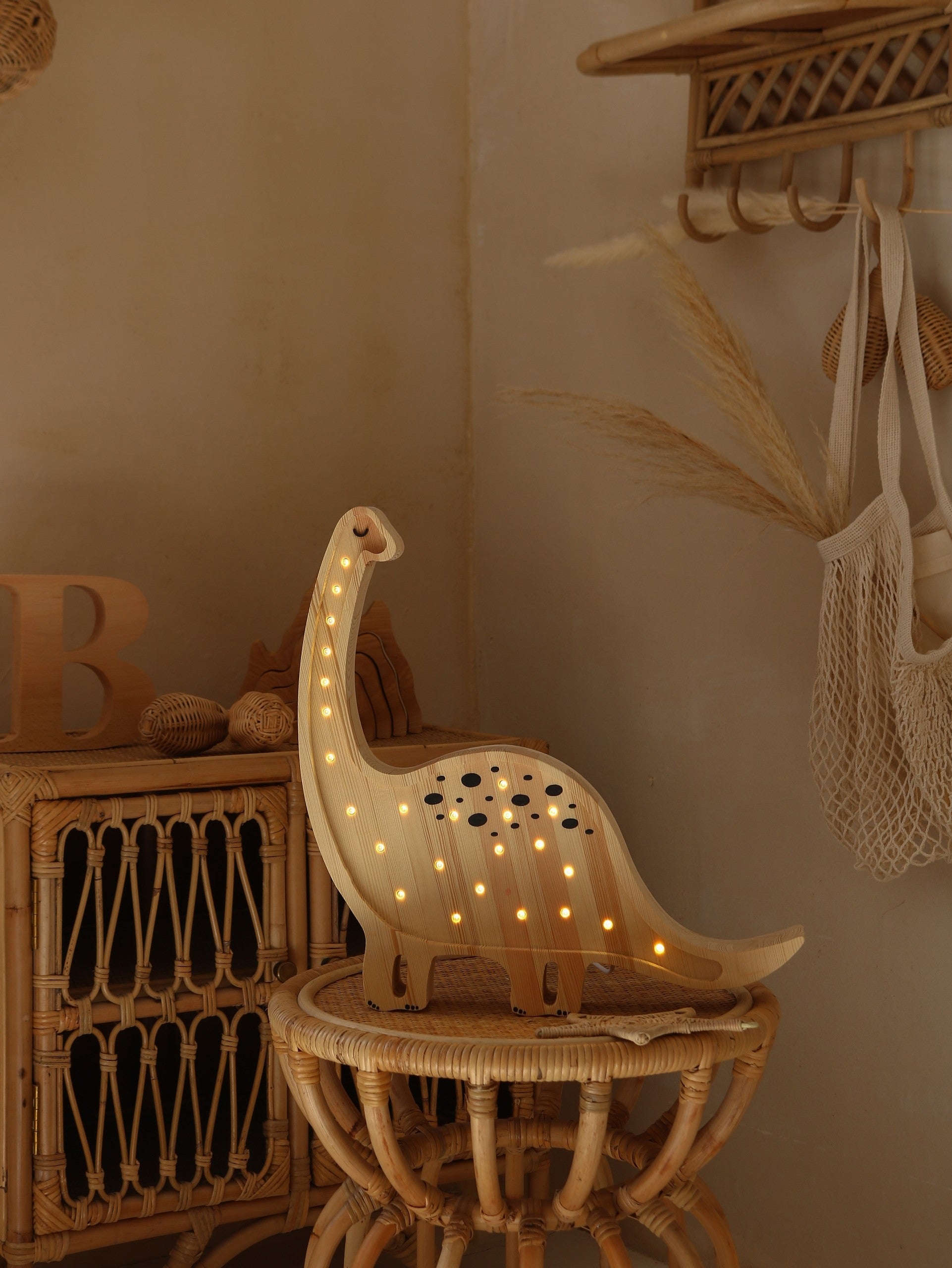 bold diplodocus lamp casting a warm glow in a modern childs bedroom