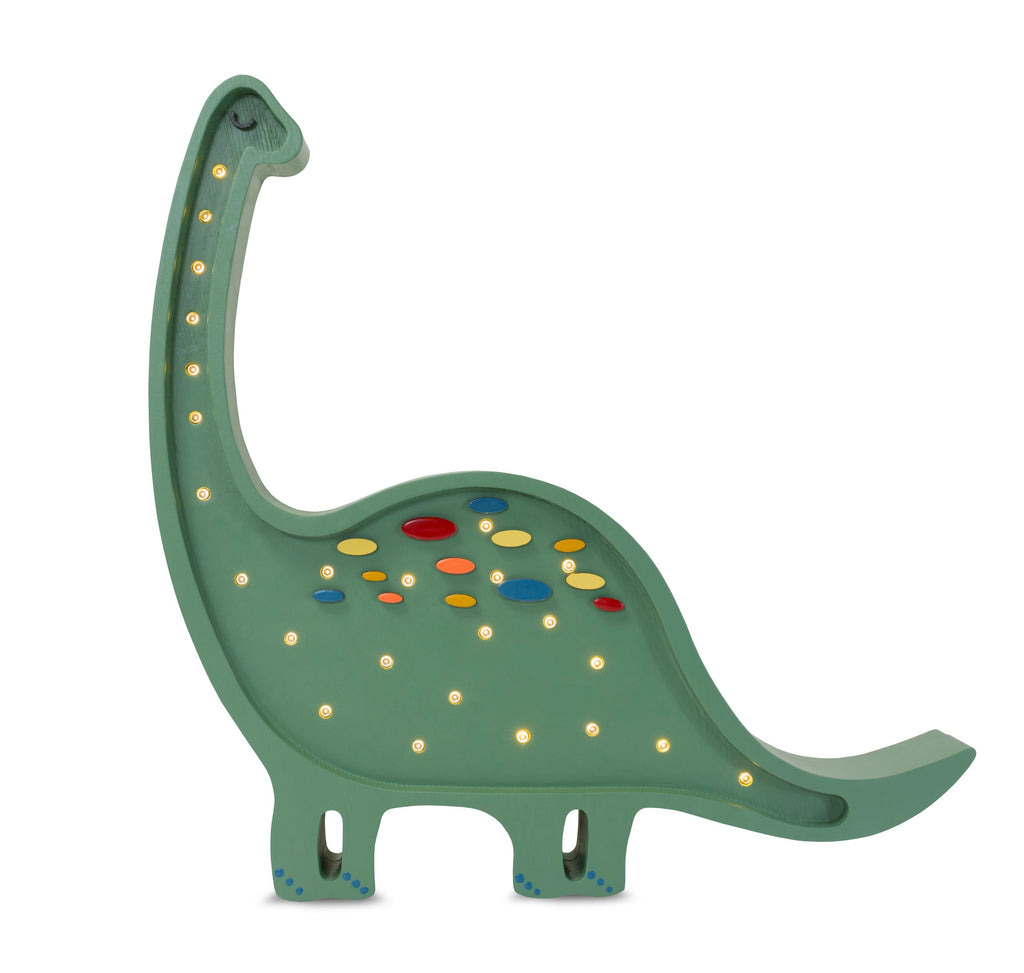 handmade diplodocus lamp casting a warm glow on a bedside table
