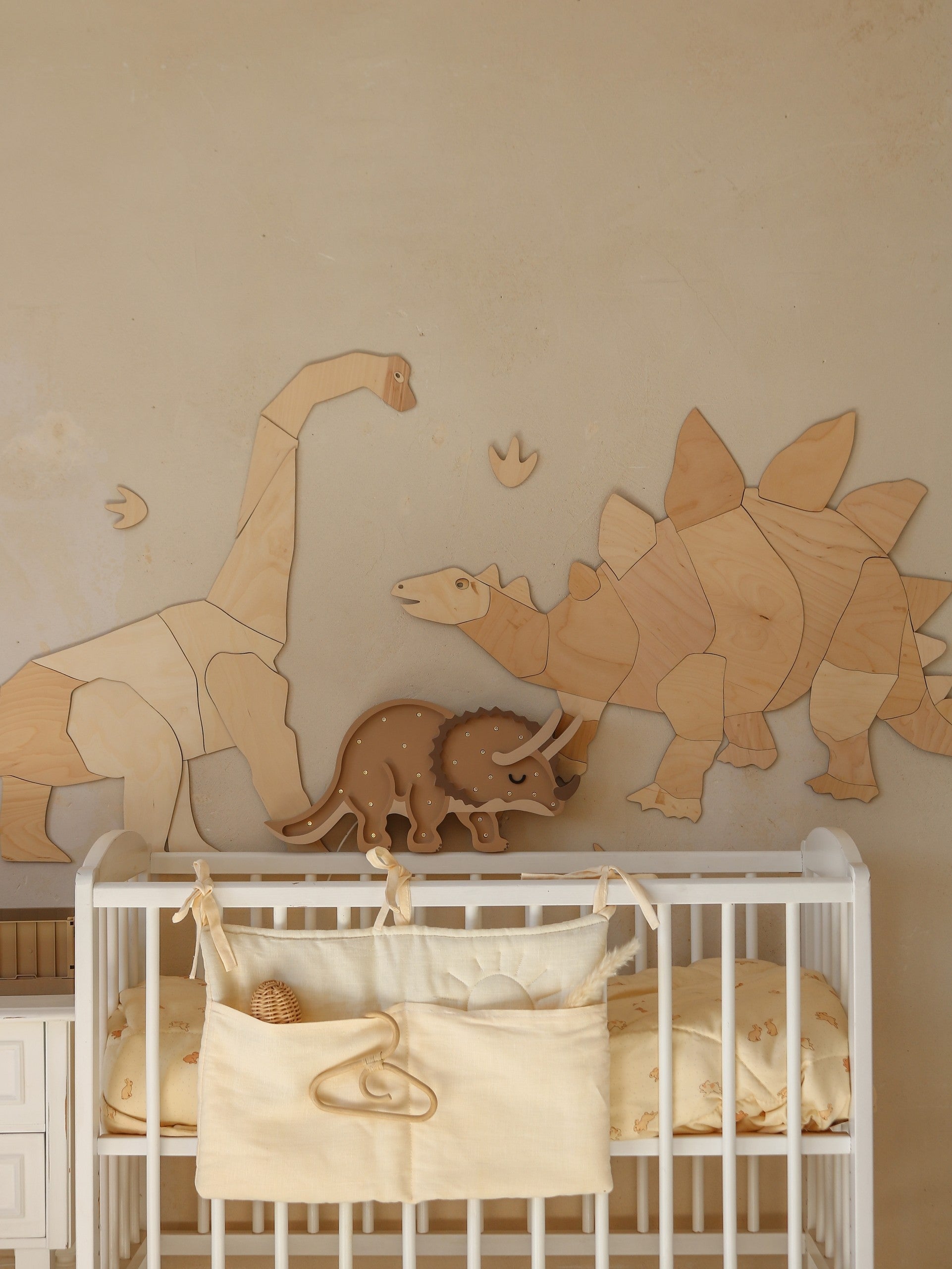 dino triceratops lamp on a nightstand showing its smart timer and dimmer controls