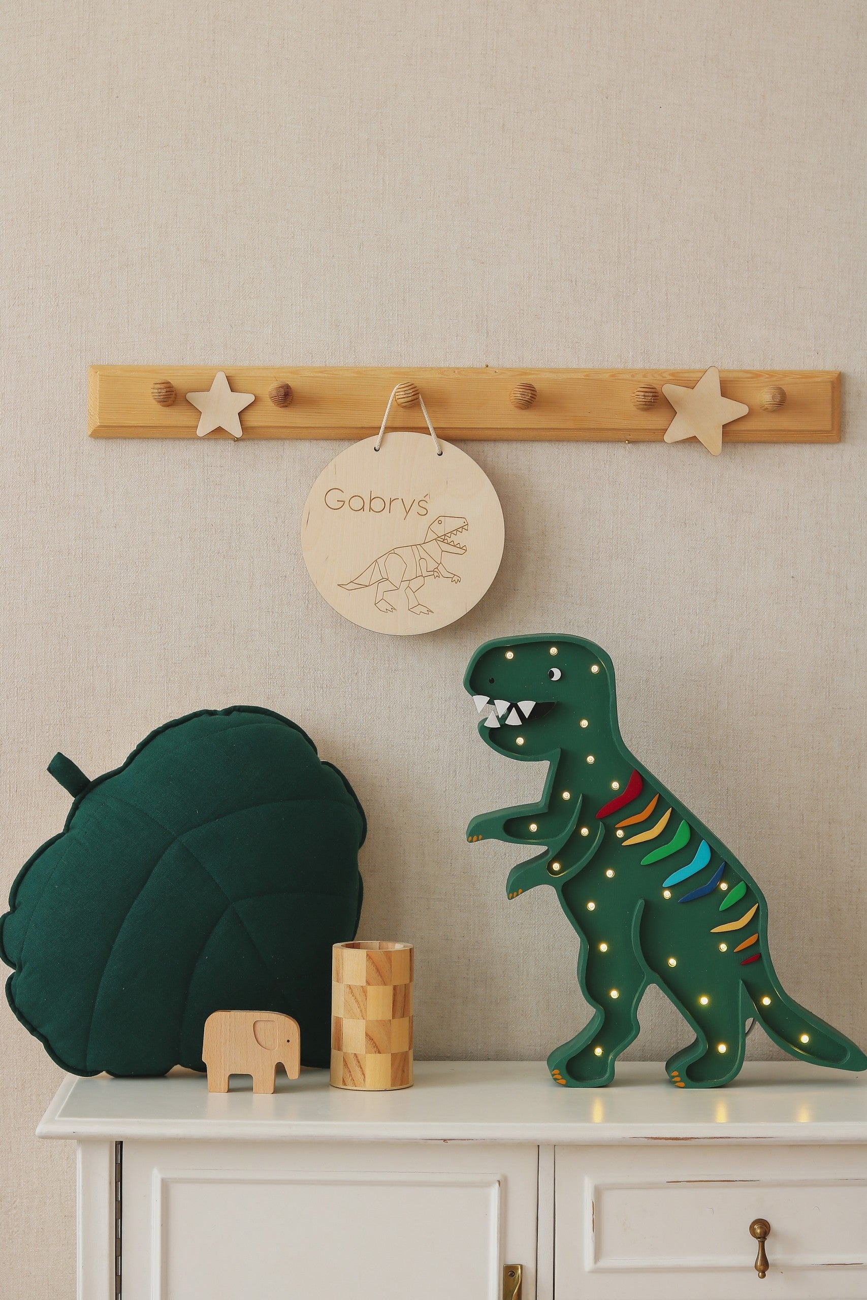 bold t-rex dinosaur lamp glowing warmly in a dark room