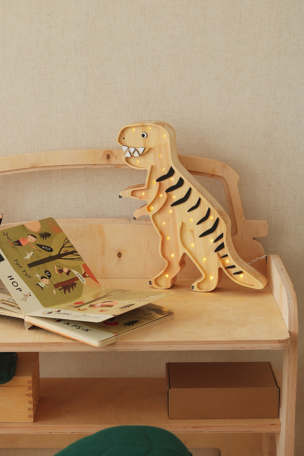 close-up of the t-rex lamp's dimmer switch and power cord for easy bedtime use