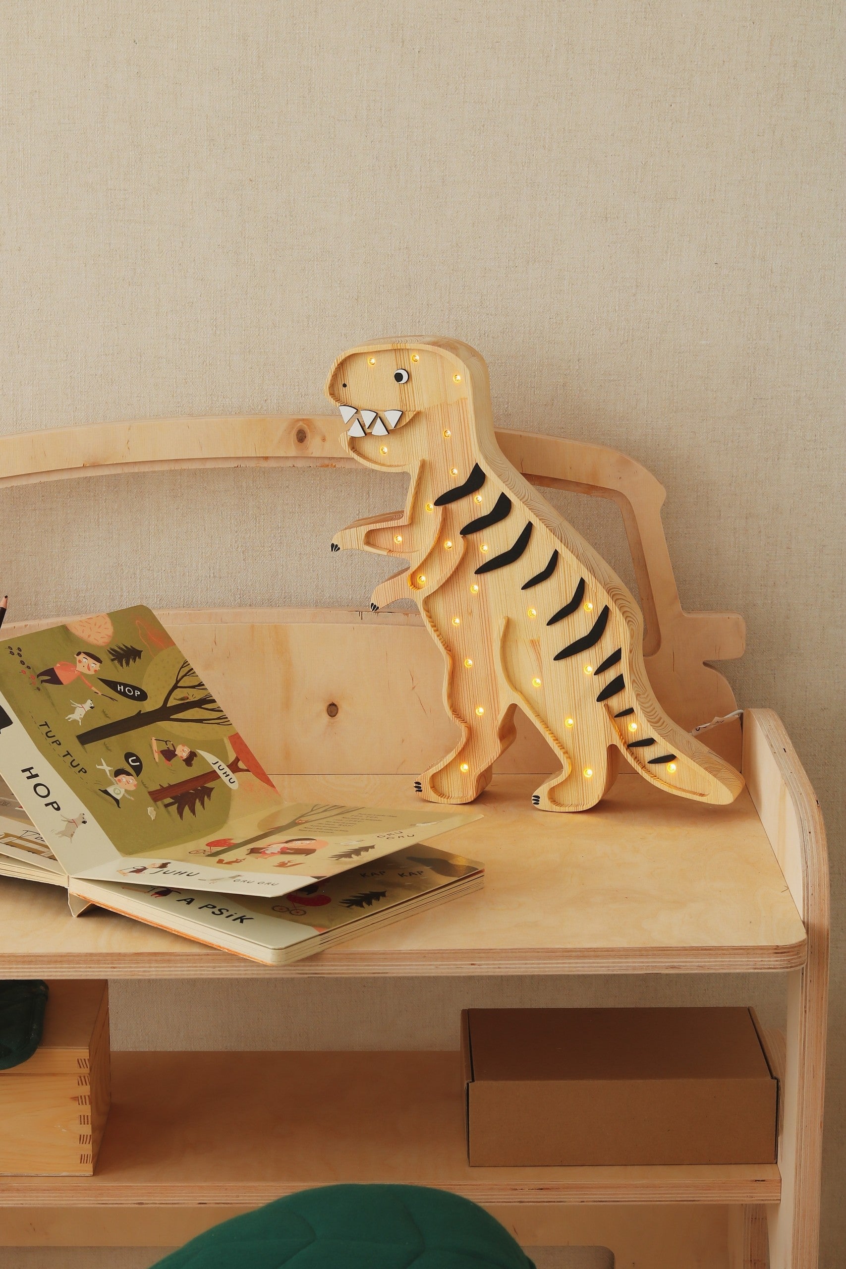 close-up of the t-rex lamp's dimmer switch and power cord for easy bedtime use