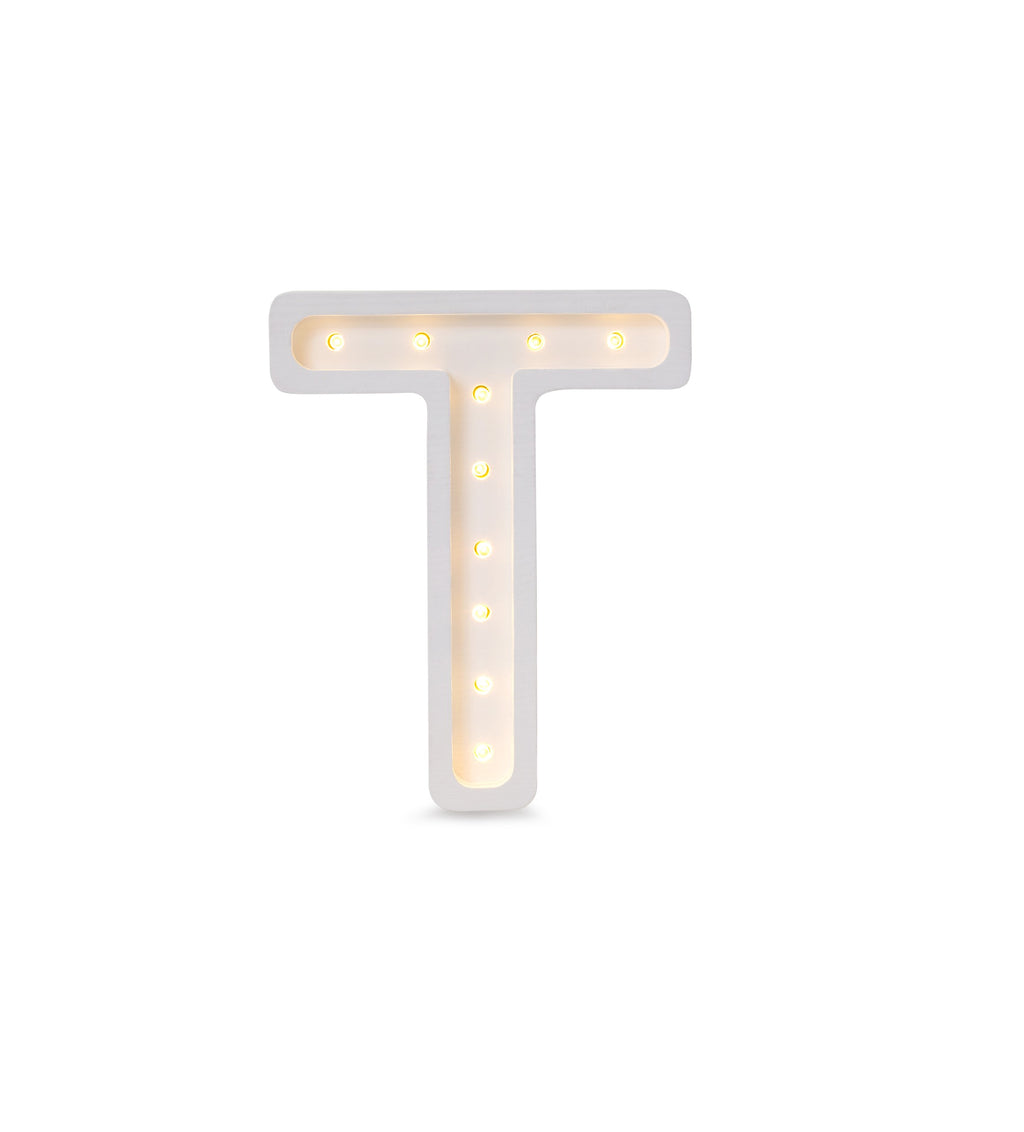 bold solid pinewood letter t lamp casting a warm glow on a modern nursery shelf