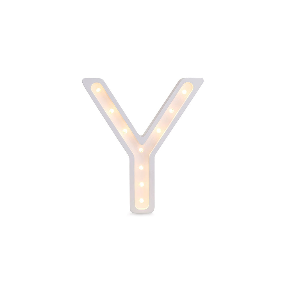 bold solid pinewood letter y lamp casting a dramatic warm glow in a dark nursery