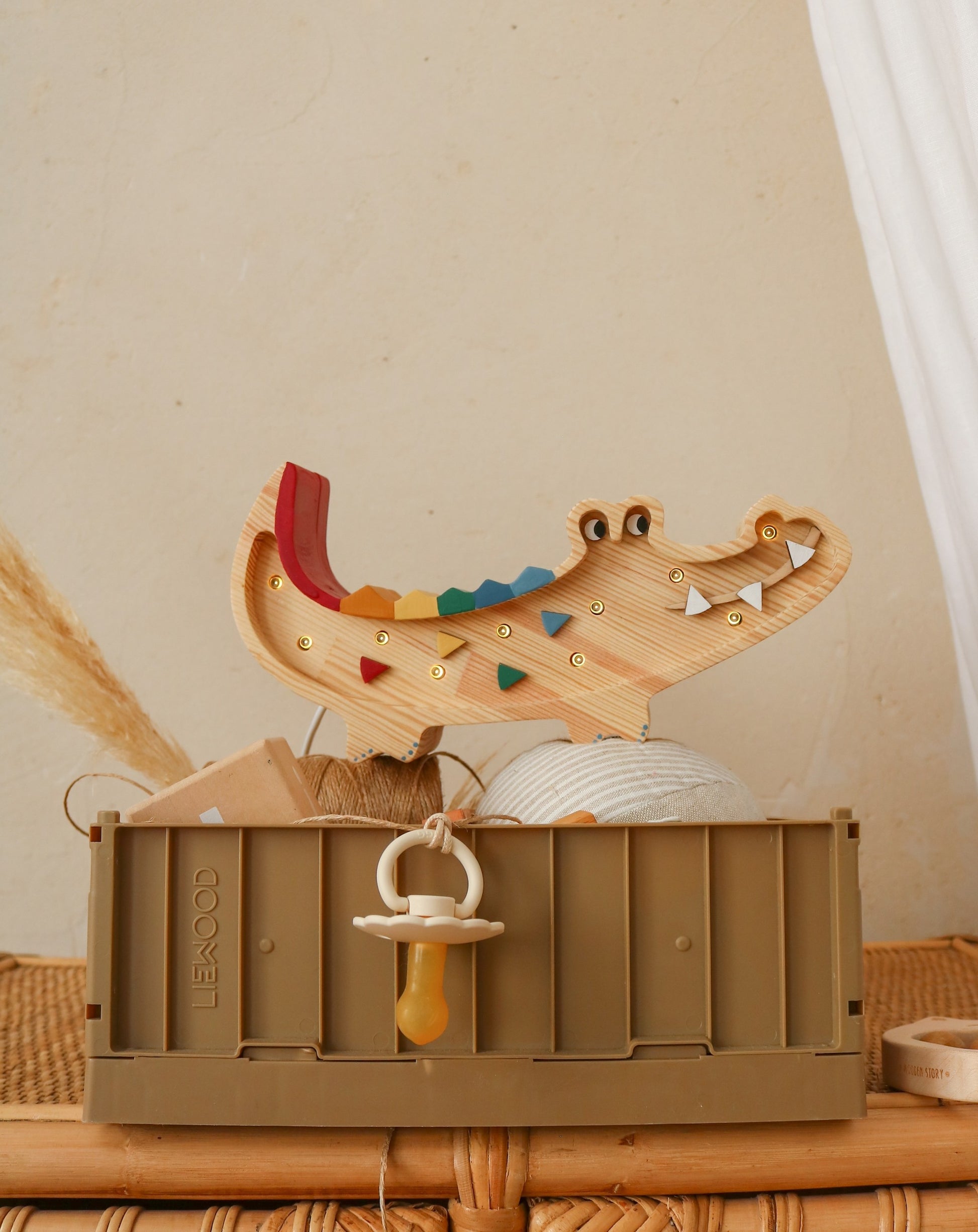 confident close-up of the charming mini crocodile lamp in warm pine wood, glowing with a bold, inviting light