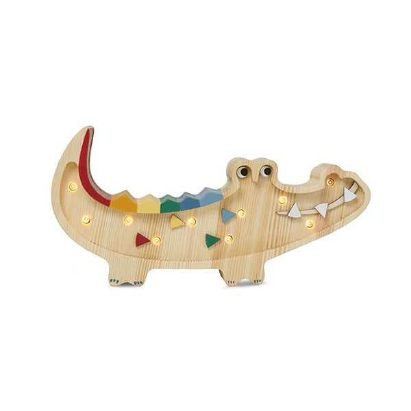 handmade wooden crocodile night light casting a soft, warm glow on a nursery shelf