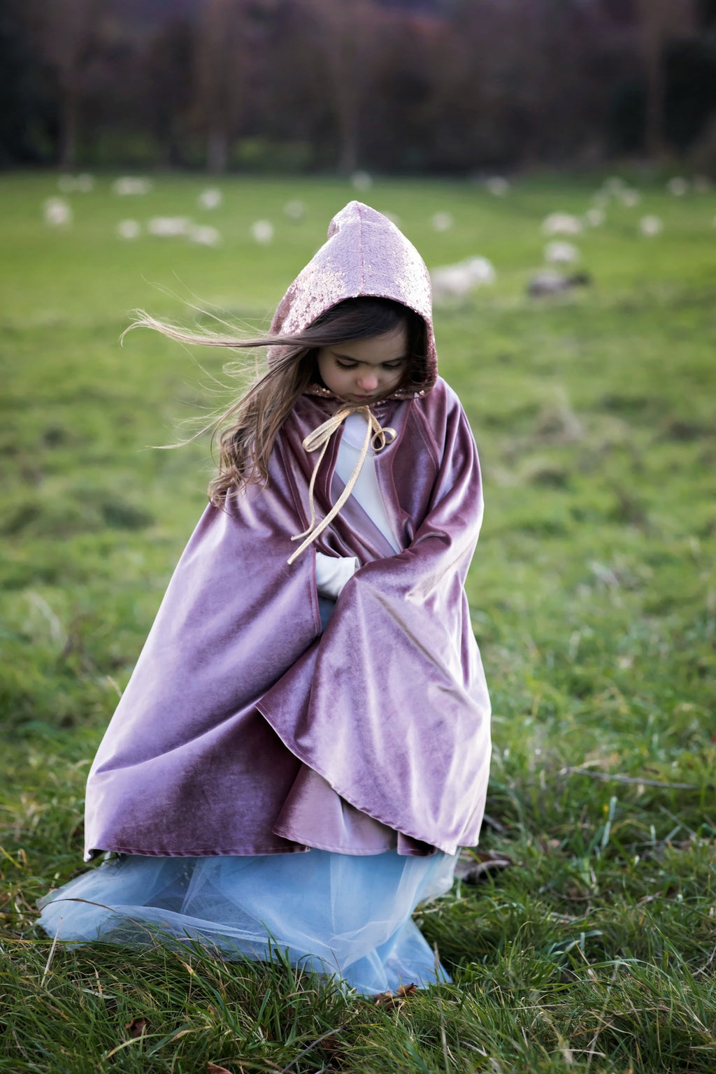 child in cosmic pearl magic cape twirling with hands through velour hand holes