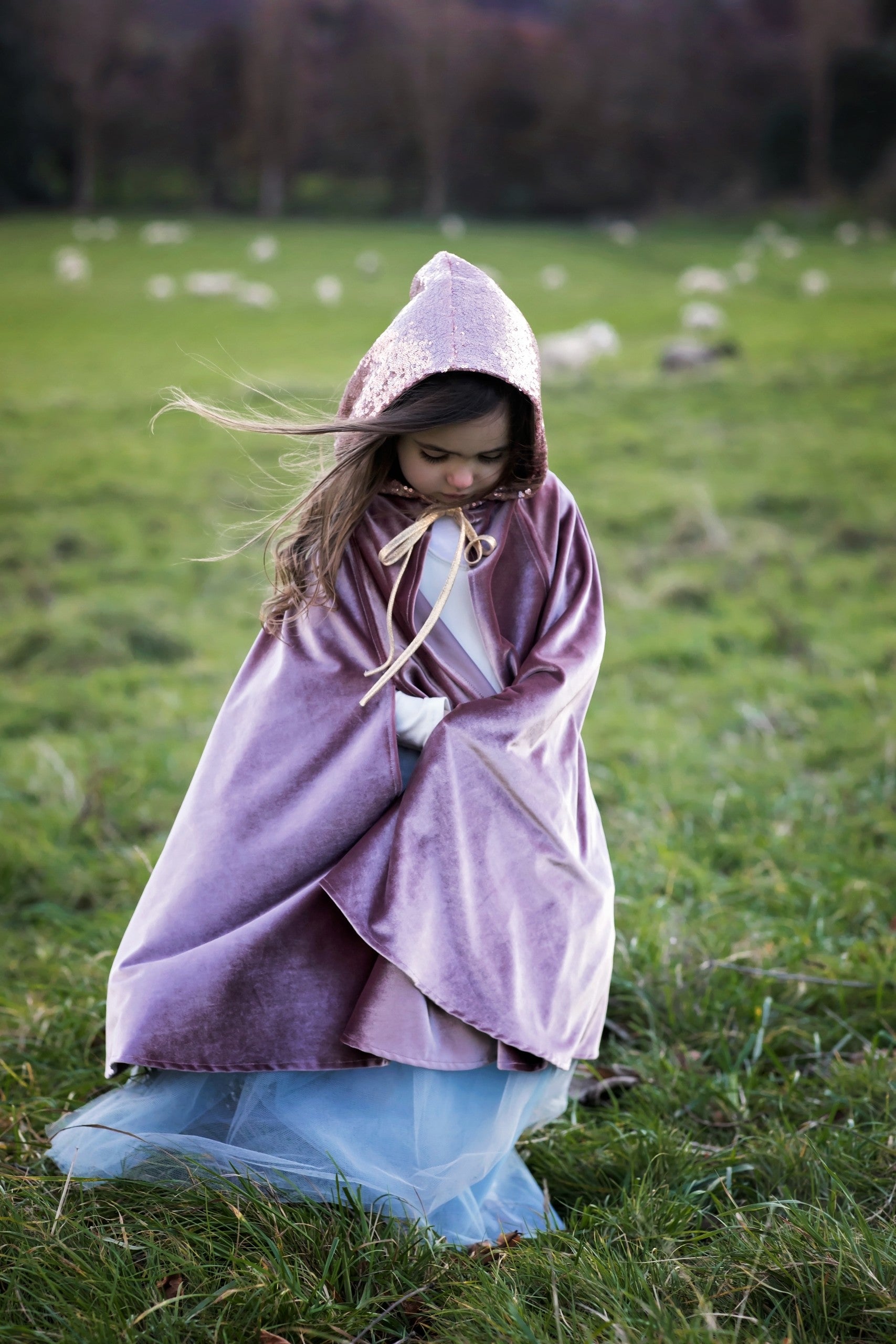 child in cosmic pearl magic cape twirling with hands through velour hand holes