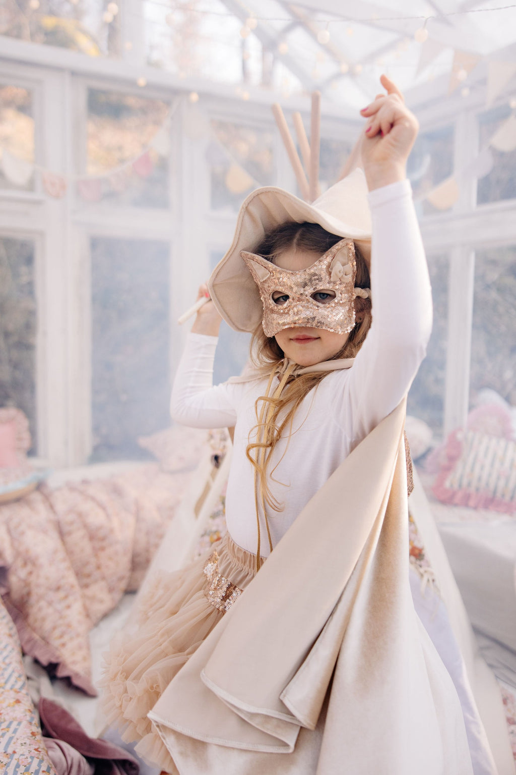 elegant cream pearl velour cape with a deep hood and snap fastening, shown from a refined angle