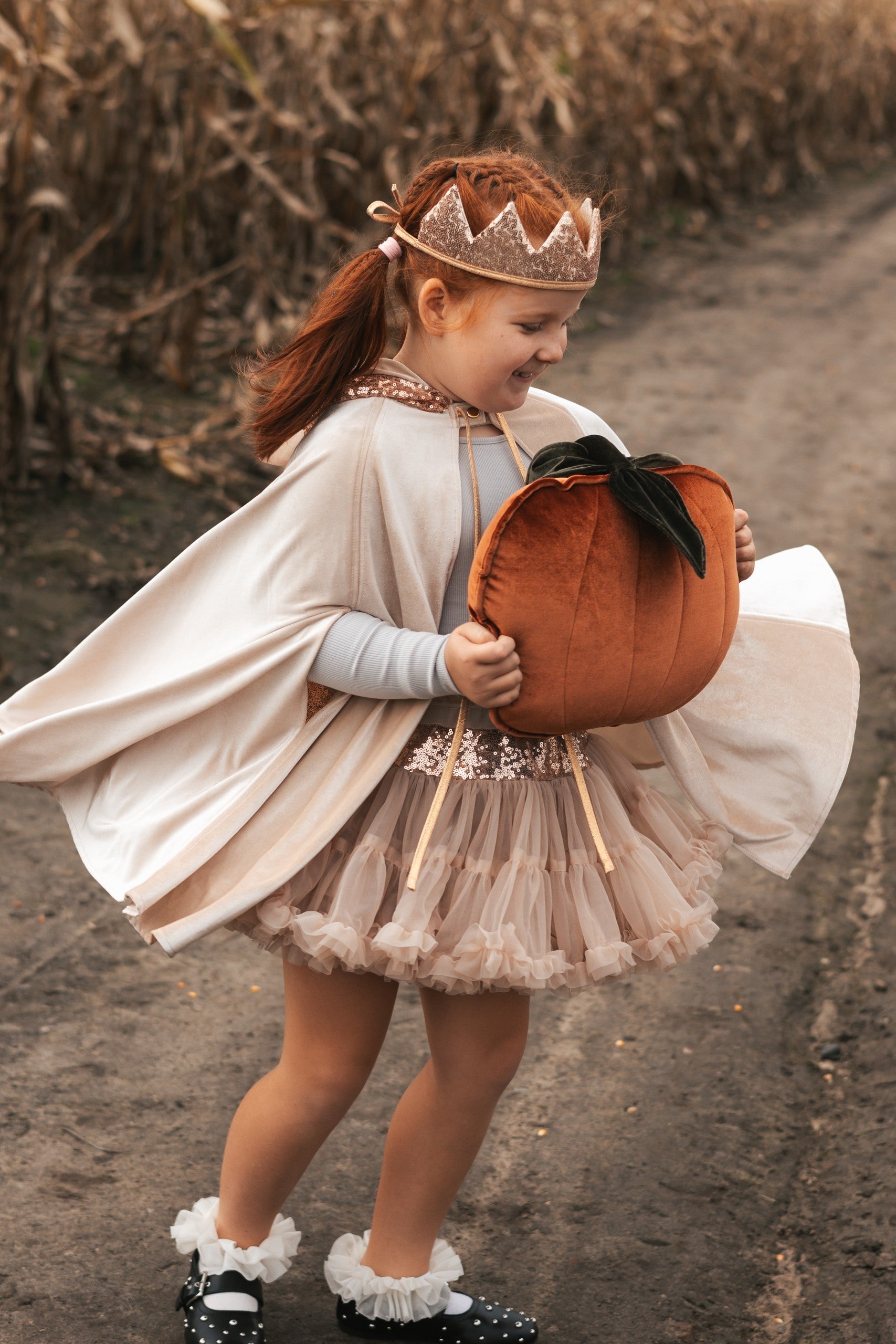 elegant cream velour magic cape with pearl details and a deep hood, shown from a refined angle