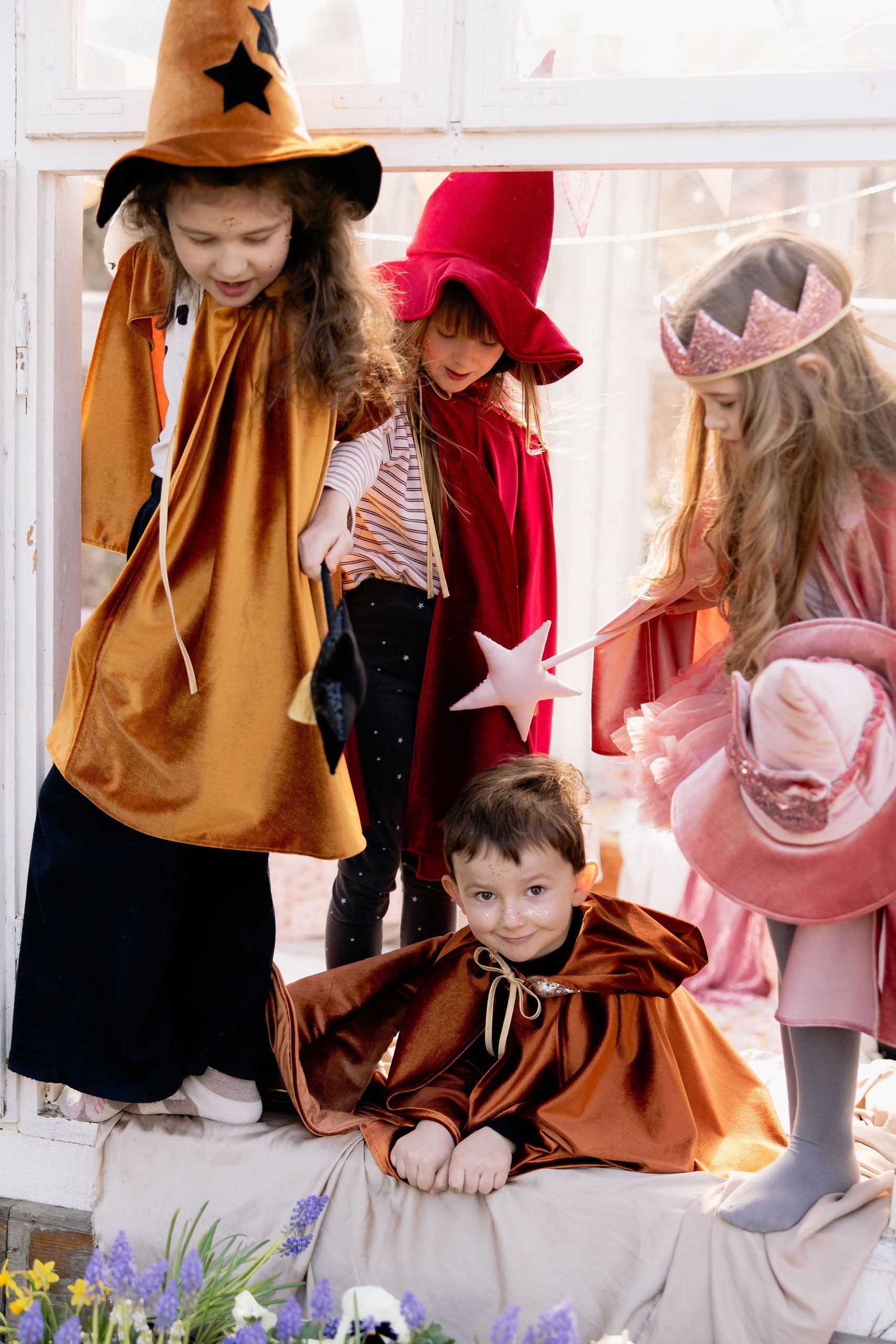 elegant golden velour kids cape with a deep hood and snap closure, shown in a refined portrait