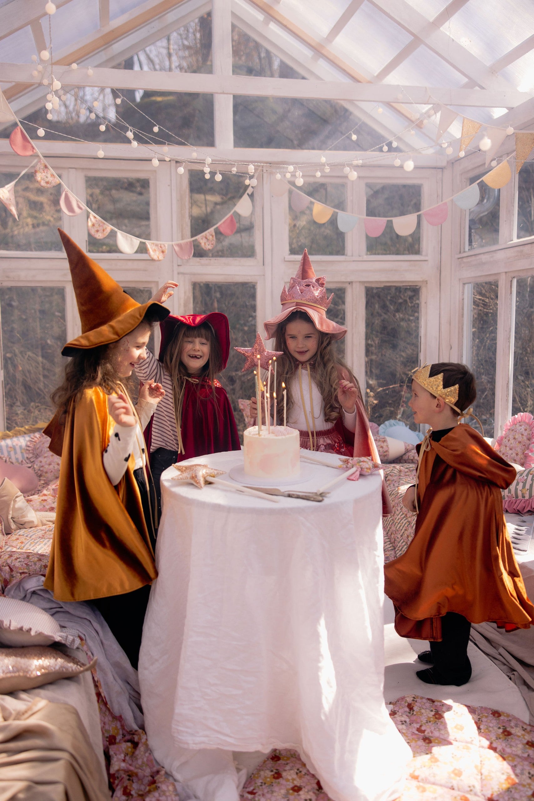 a child in a ginger velour hooded cape playing outdoors in the sunlight