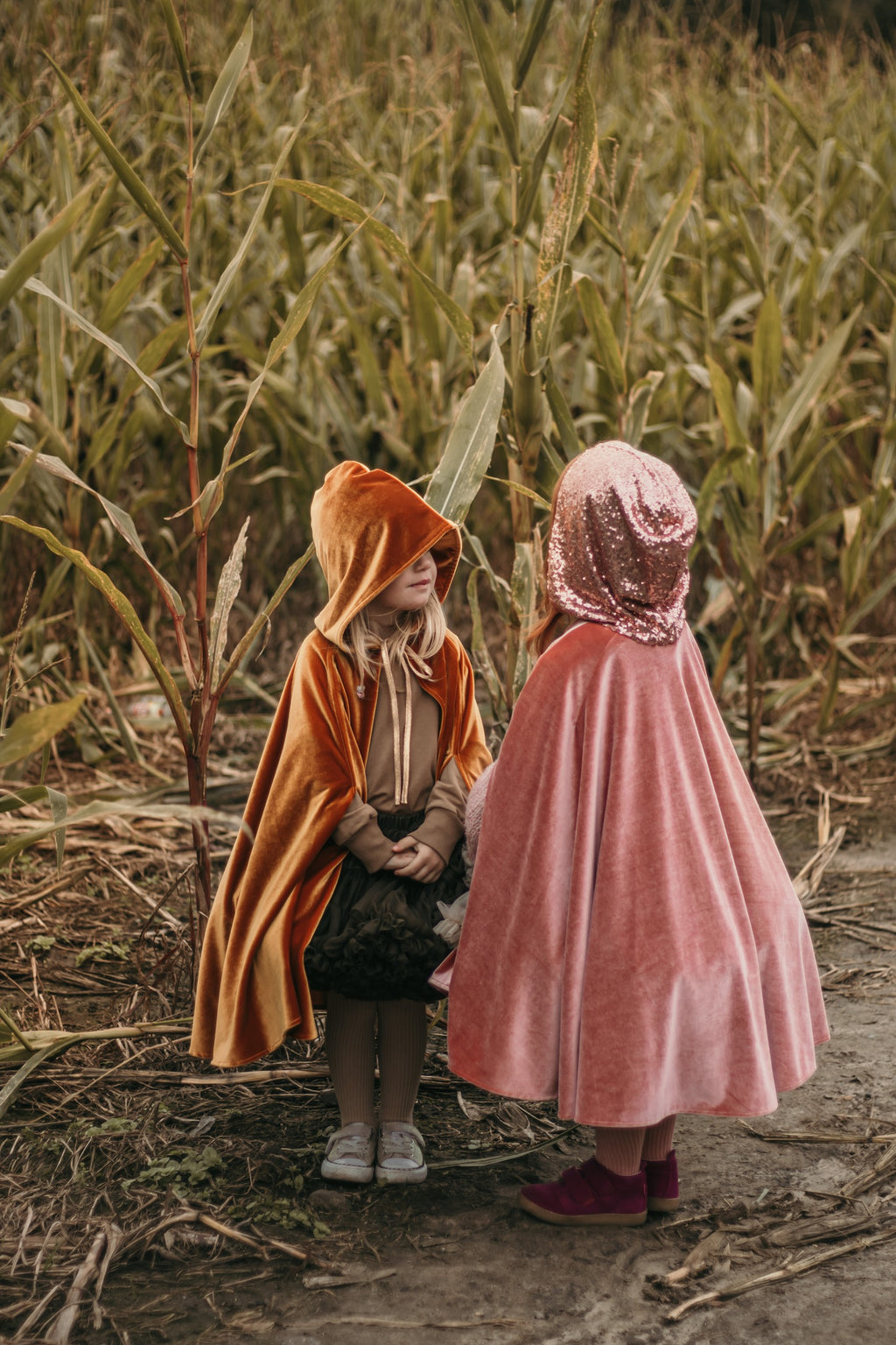 pink velour magic cape with deep hood and snap fastening, perfect for fairy tale adventures and playtime