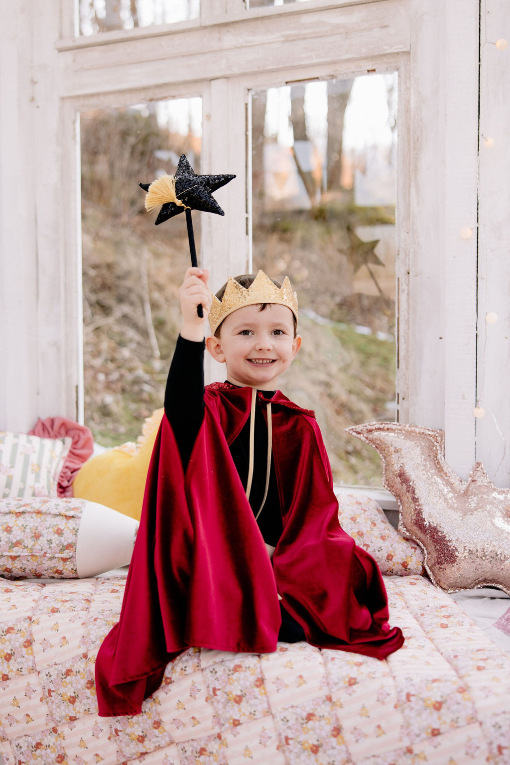 red riding hood cape in soft velour, shown from a functional angle highlighting the secure snap closure and convenient hand holes