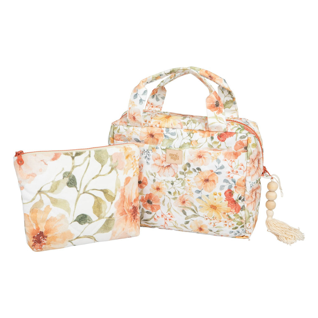 handmade cotton makeup bag set with floral print laid on a rustic wooden table