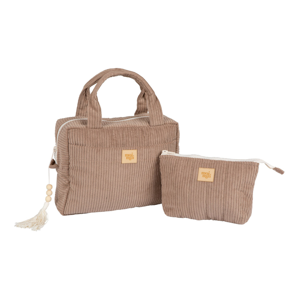 moi mili latte makeup bag set of two laid flat on a rustic wooden table