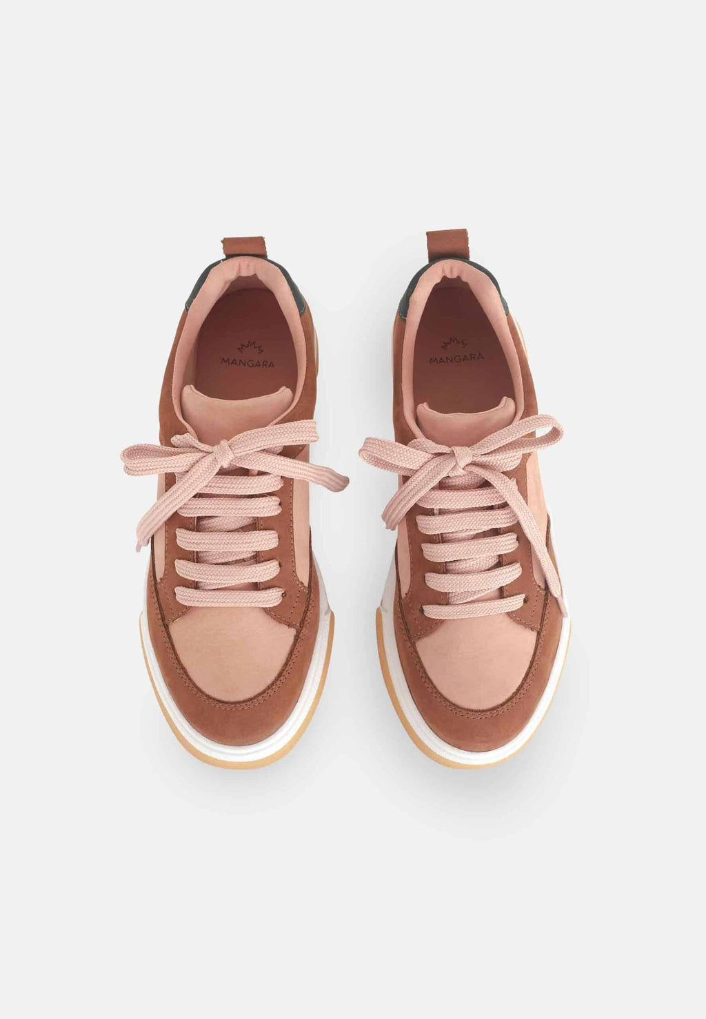playful side view of women's multicolor suede sneakers on a bright urban street