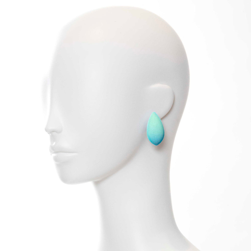 bold close-up of mega dream day earrings with cosmic dust shimmering under dramatic studio lighting