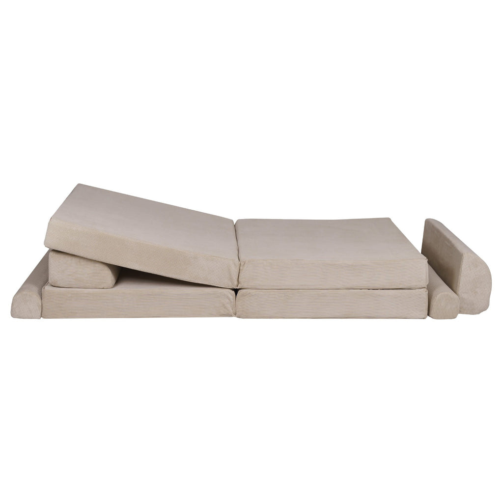 a child peeking over the back of the soft ecru sofa during a playful game of hide-and-seek
