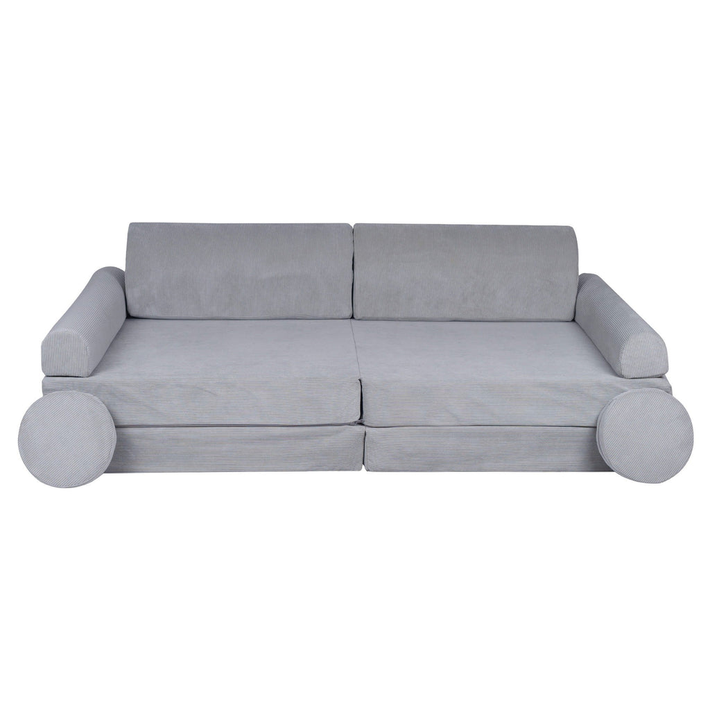 gray corduroy kids sofa bed shown in a bright playroom with two matching poufs arranged practically for storage
