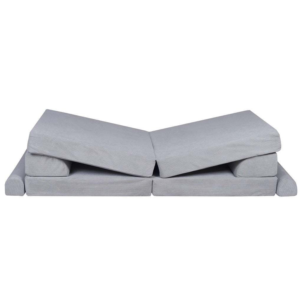 a playful gray corduroy kids sofa bed with two poufs in a bright, sunlit playroom