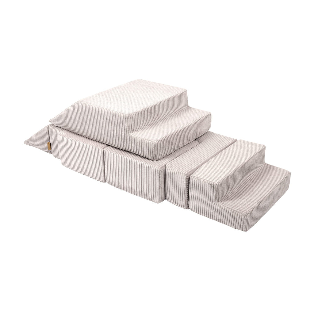 an elegant ecru velvet play sofa arranged in a sophisticated living room setting