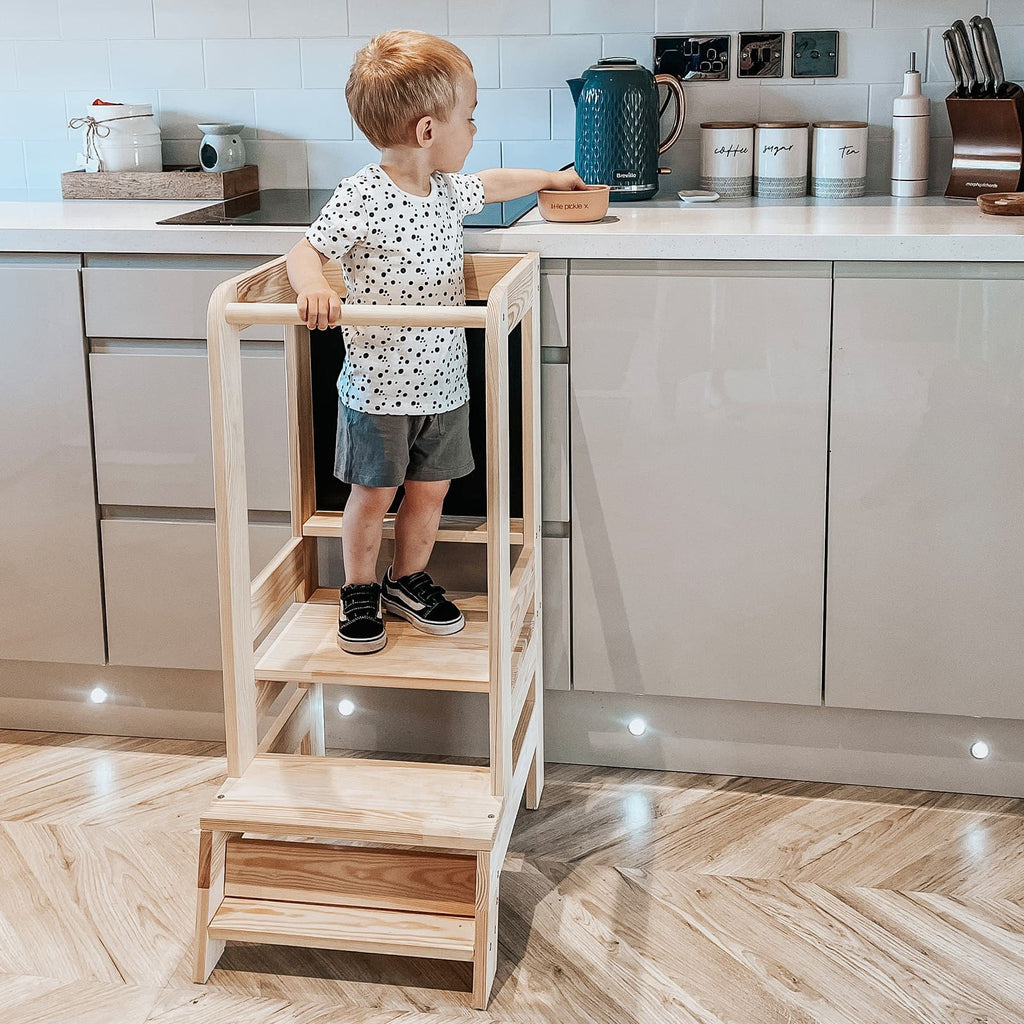 confident toddler reaching kitchen counter on a sturdy meowbaby wooden helper tower
