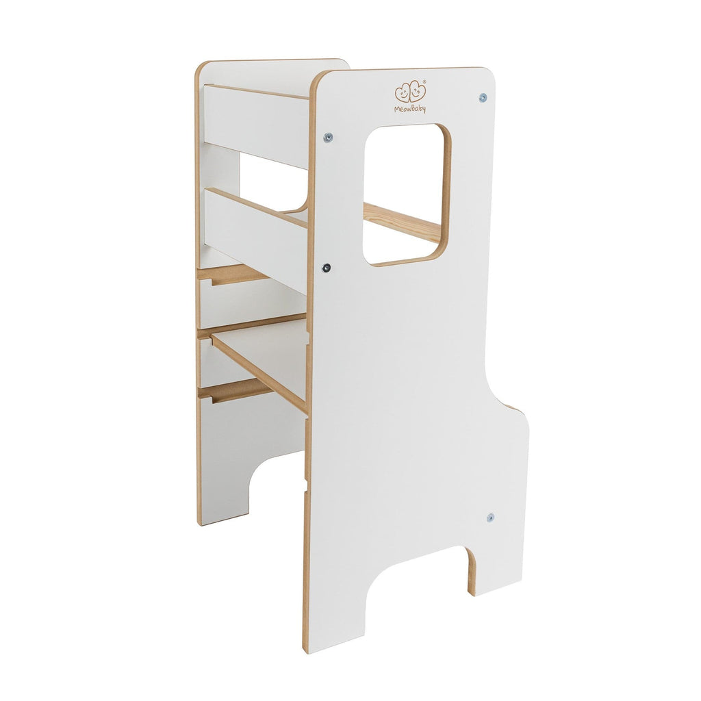 a child safely standing in a wooden kitchen helper tower, bathed in soft morning light