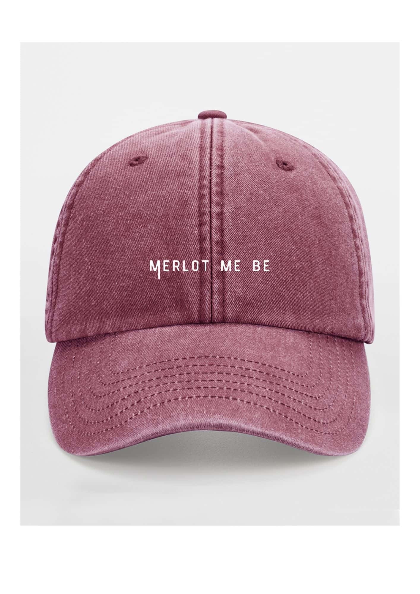 a bold merlot me be cotton cap in dramatic low-key lighting, showcasing its confident, unstructured shape